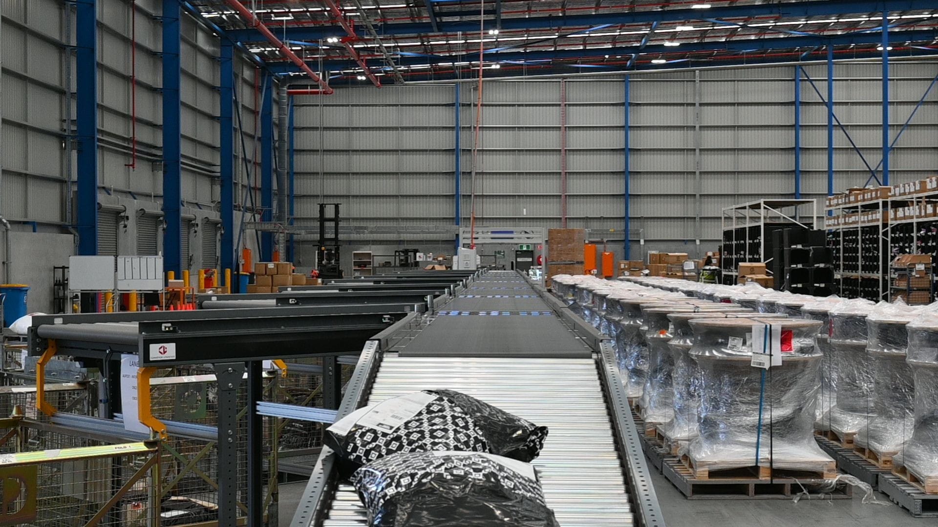 Belt Conveyor with diverters that direct parcels to corresponding shipping box.